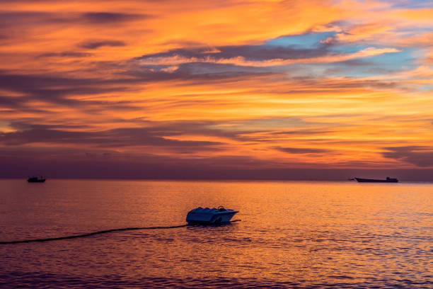Colorful sunset over the sea with boats, Vietnam