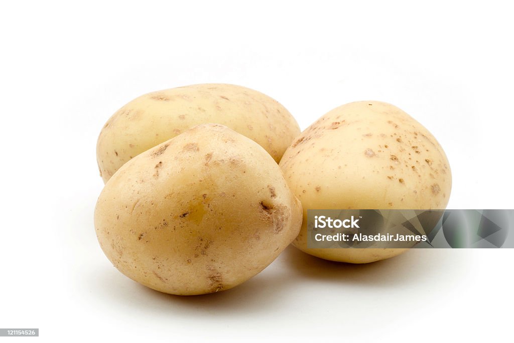 Tre patate - Foto stock royalty-free di Patata cruda