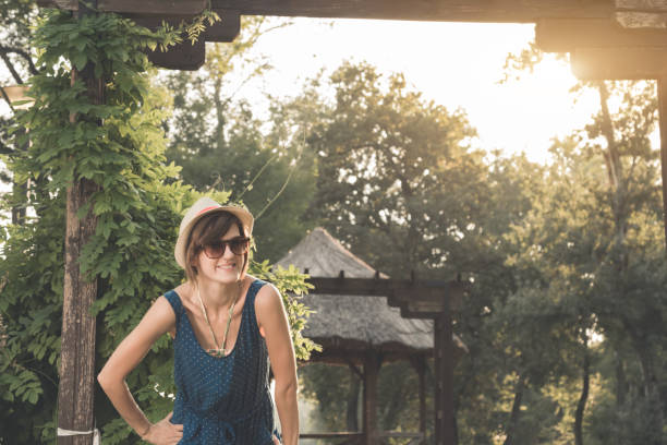 istock Cute young woman posing outdoors in summertime sunlight. 1211545260