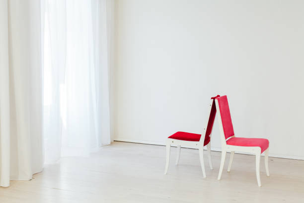 istock two vintage chairs in an empty white room 1211546002