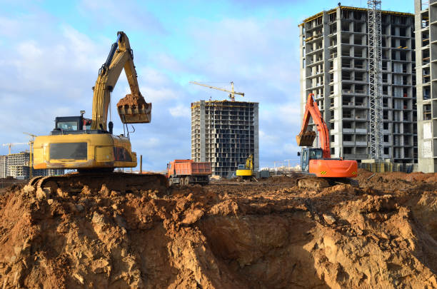 istock Group of the excavators for dig ground trenching at a construction site 1211550382