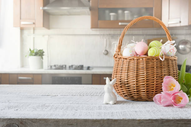istock Wicker basket with bunny, tulip, easter colorful eggs on kitchen wooden table. Spring easter composition. Space for text. 1211551266