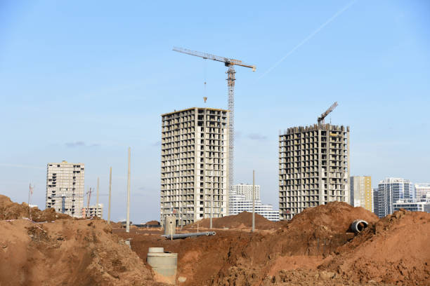 istock Drainage pipes at the large scale construction site against tower cranes 1211551325