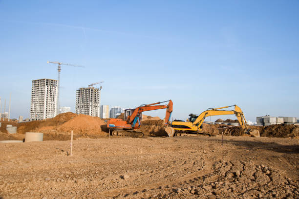 istock Group of the excavators for dig ground trenching at a construction site 1211551458