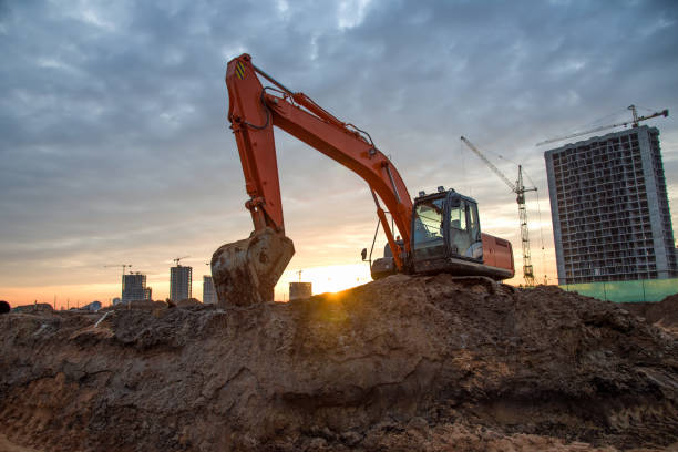 istock Excavator on earthworks at construction site on sunset background 1211551805