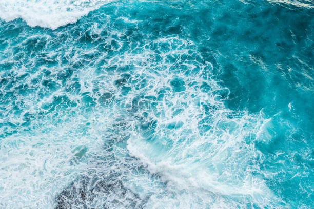 istock Big ocean waves hitting a coral rif. View from above. 1211552458