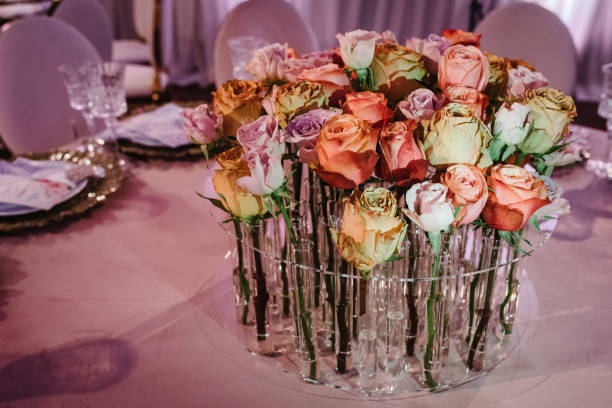 istock Beautiful decor with floral decorations on wedding ceremony. Festive table newlyweds decorated with composition of flowers and greenery in the banquet hall. 1211552776