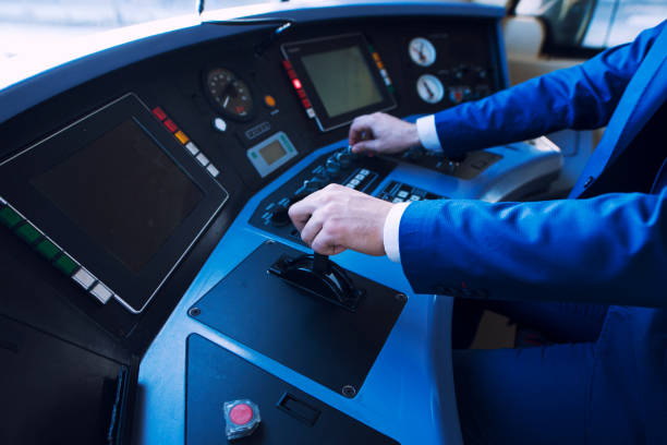 istock Shot of an unrecognizable professional driver in uniform operating in train cockpit and driving high speed train. Transportation services and occupation. 1211552824