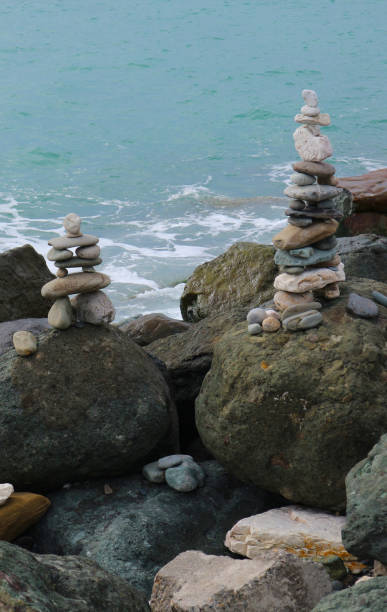 istock Stone cairn on seacoast. Big rocks and balanced pebbles stack. Relaxation, harmony, balance concept. 1211552991
