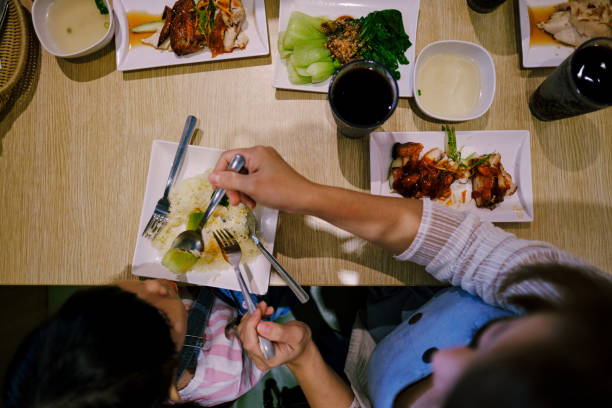 istock Mother and Daughter Eating Together 1211553114