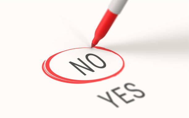 istock Red Marker Highlights Selects and Marks No on White Paper 1211553932