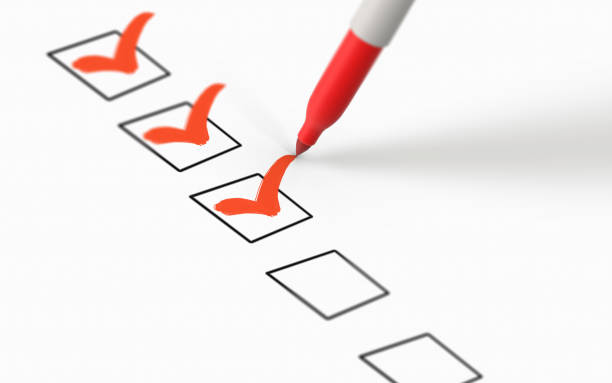 istock Red Marker Highlights Selects and Marks Check Boxes with OK Sign on White Paper 1211553966