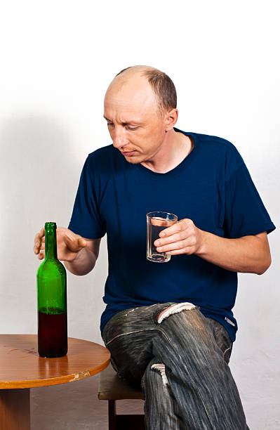男性、ガラスと赤ワインのボトル - eastern european caucasian one person alcoholism ストックフォトと画像