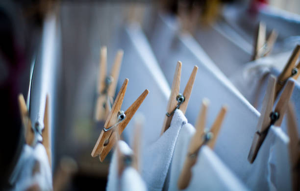 Clothes pegs on the clothesline Clothes pegs on the clothesline with cotton white clothes clothespin wood stock pictures, royalty-free photos & images