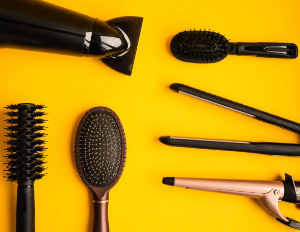 istock Professional hair dresser tools on yellow background with copy space, top view 1211554529