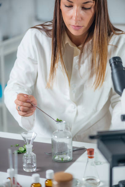 istock Homeopathy. Homeopath preparing herbal remedies 1211554612