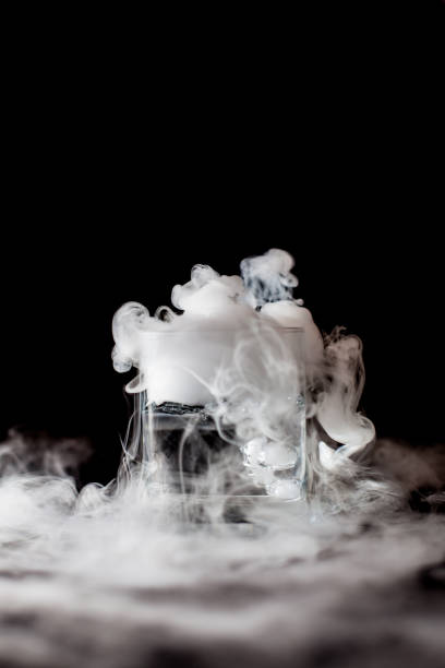 istock Glass with white smoke at dark background 1211555589
