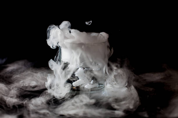 istock Glass with white smoke at dark background 1211555605