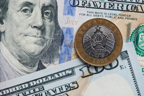 istock Two  Belarusian rubles coin on dollar background 1211556667