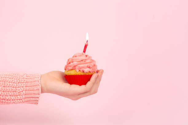 istock Monochrome birthday concept with cupcake and pink frosting. Copy space. 1211556909