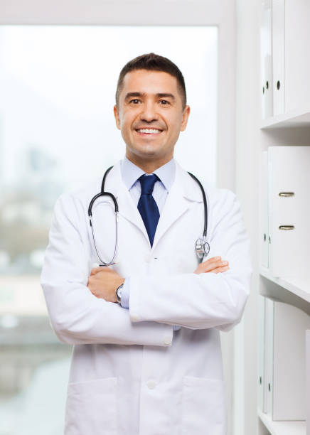 istock smiling doctor in white coat at medical office 1211557123