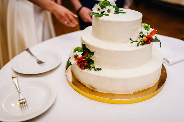 istock White wedding cake with flowers for wedding banquet. Delicious reception. Copy space. Celebration party concept. Trendy Cake. 1211557238