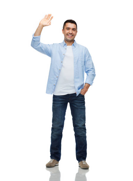 smiling man waving hand happiness and people concept - smiling man in shirt and jeans waving hand waving stock pictures, royalty-free photos & images