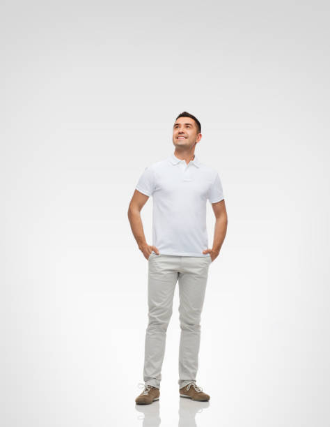istock smiling man with hands in pockets looking up 1211558272