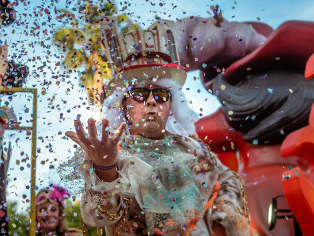 Carnival parade ALGECIRAS, SPAIN - February 28, 2020: Carnival participants celebrating in the street in Algeciras, Cadiz, Andalusia, throwing confetti. cádiz stock pictures, royalty-free photos & images
