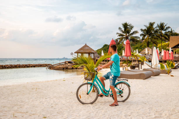 istock Praslin Seychelles,young men on tropical beach with palm tree, white beach man walking Seychelles Island, tanning men on tropical vacation 1211562944