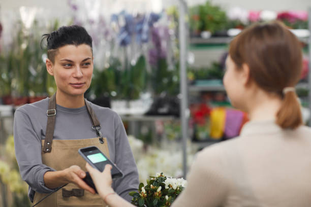 istock Customer Paying by NFS in Flower Shop 1211564852