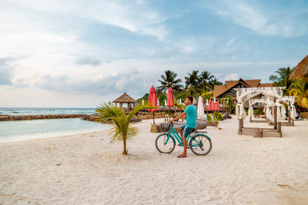 istock Praslin Seychelles,young men on tropical beach with palm tree, white beach man walking Seychelles Island, tanning men on tropical vacation 1211566404