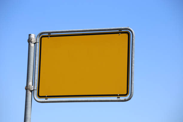 Four directional signs against a clear blue sky in alternately opposite directions.jpg