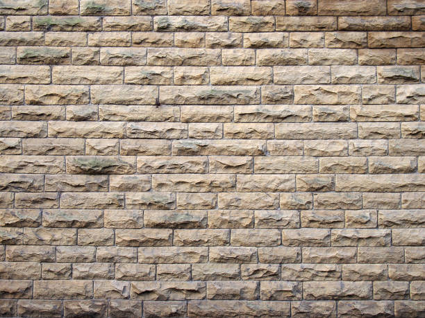 istock a full frame image of an old yellow sandstone wall made of regular blocks 1211566747