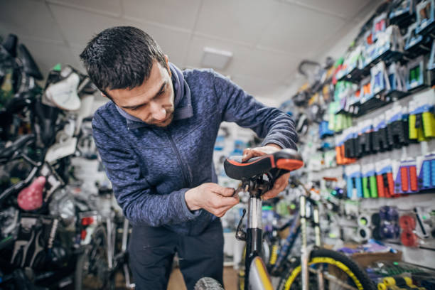 istock One man, repairing a bicycle in his work shop. 1211568051