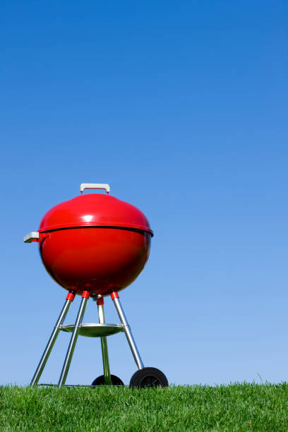 istock Red Barbecue Grill against a Blue Sky 1211568087