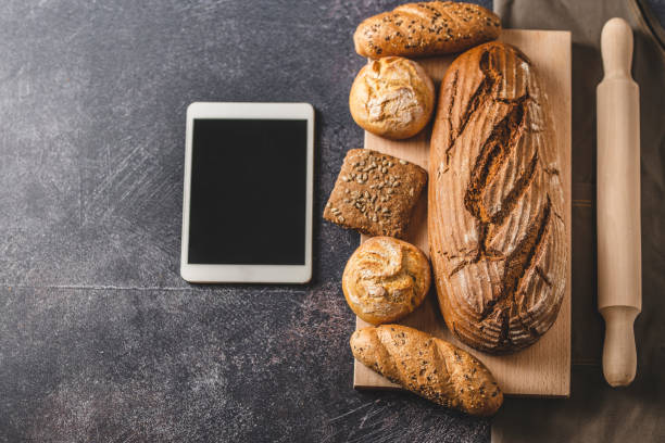 istock Fresh pastries, rolling pin and digital tablet 1211568163