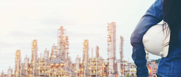 istock Engineer inspector construction building power plant energy industry in project site.  Close up hand woman worker holding white helmet for security control refinery plant. 1211569813