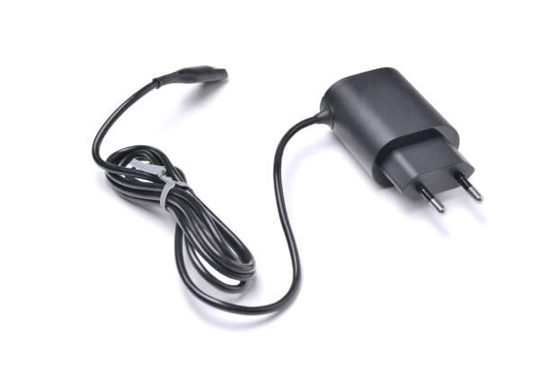 istock Charger for gadgets in black with cable and connector, isolated on a white background with a shadow 1211571335