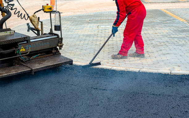 istock Worker regulate tracked paver laying asphalt heated to temperatures above 160 ° pavement on a runway 1211571577