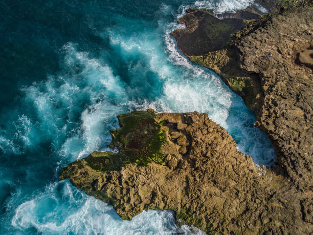 istock Waves crashing on rocks seen from above 1211573446