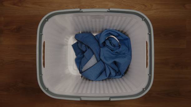 istock TOP VIEW: Single cloth in a laundry basket on a floor 1211573751