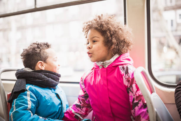istock Mixed race siblings traveling with a tram 1211573939