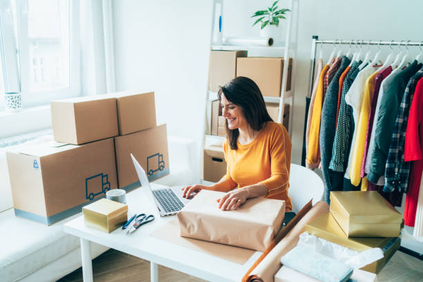 Small business owner Young woman are preparing a package for delivery to clients. Online clothing store market vendor stock pictures, royalty-free photos & images