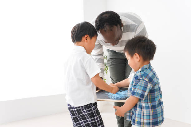 istock Children study at International School with native teacher 1211575092