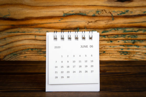istock 2020 June. White paper calendar on a wooden table 1211575202