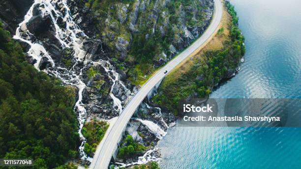 Aerial View Of Scenic Mountain Road With Car Sea And Waterfall In Norway Stock Photo - Download Image Now