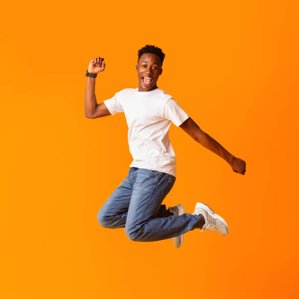 istock Excited screaming african man jumping while celebrating 1211577850