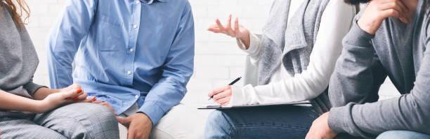 Unrecognizable people discussing their problems with psychologist at group therapy session Unrecognizable people discussing their problems with psychologist at group therapy session, cropped image, panorama alcoholics anonymous photos stock pictures, royalty-free photos & images