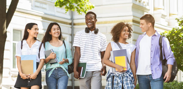 istock Happy Internatial Students Walking Outside, Going To University Together 1211578412